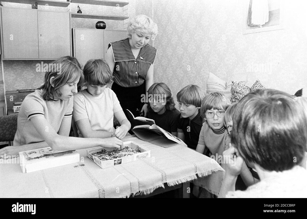 30 novembre 1981, Sassonia, Eilenburg: I bambini siedono insieme al tavolo nella casa dei bambini Zschepplin 1981 e puzzle o leggere. Data esatta di ammissione non nota. Foto: Volkmar Heinz/dpa-Zentralbild/ZB Foto Stock