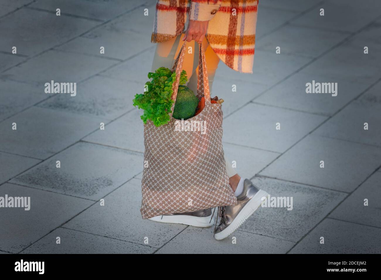Donna con borsa di prodotti tessili eco-riutilizzabili con verdure. Acquisto sano di dieta a base di piante. Zero sprechi, concetto privo di plastica Foto Stock