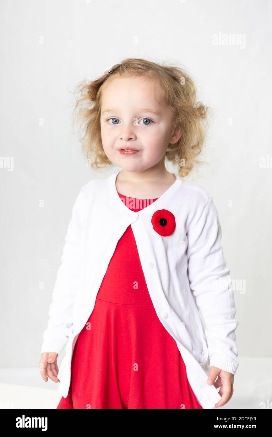 Indossa un papavero per il giorno del ricordo, un bambino dolce che indossa un papavero canadese novembre 11 Foto Stock
