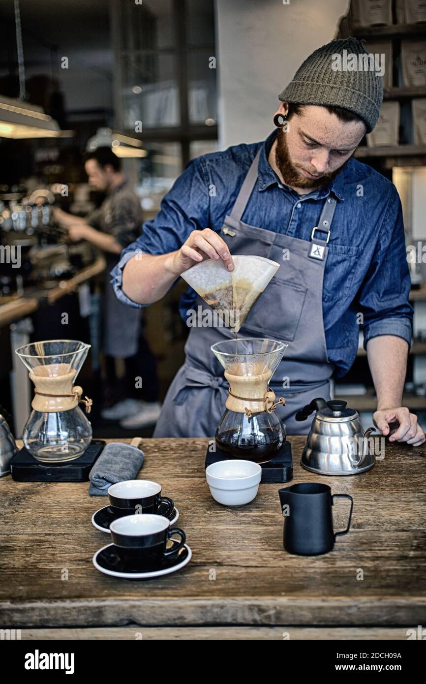 Germania / Berlino /stile caffè / Barista utilizzo di Chemex per la preparazione di caffè da filtro. Al Barn di Berlino. Foto Stock