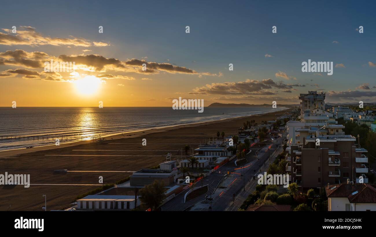 Il sole sorge sul Mare Adriatico all'alba di una nuova giornata, Rimini, Italia Foto Stock