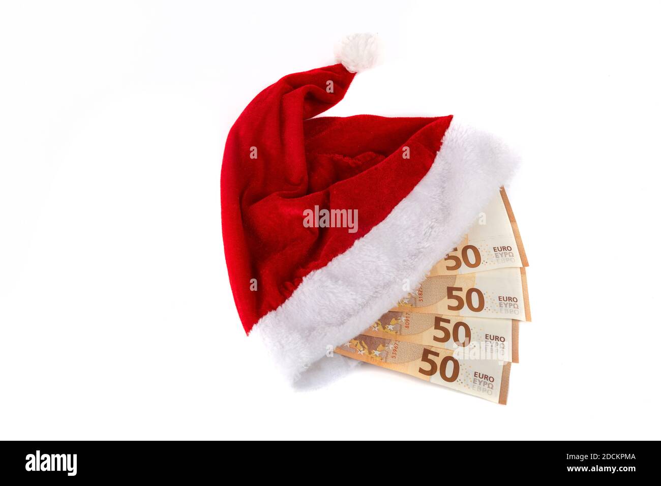 Cappello di Babbo Natale e banconote in euro su sfondo bianco Foto Stock