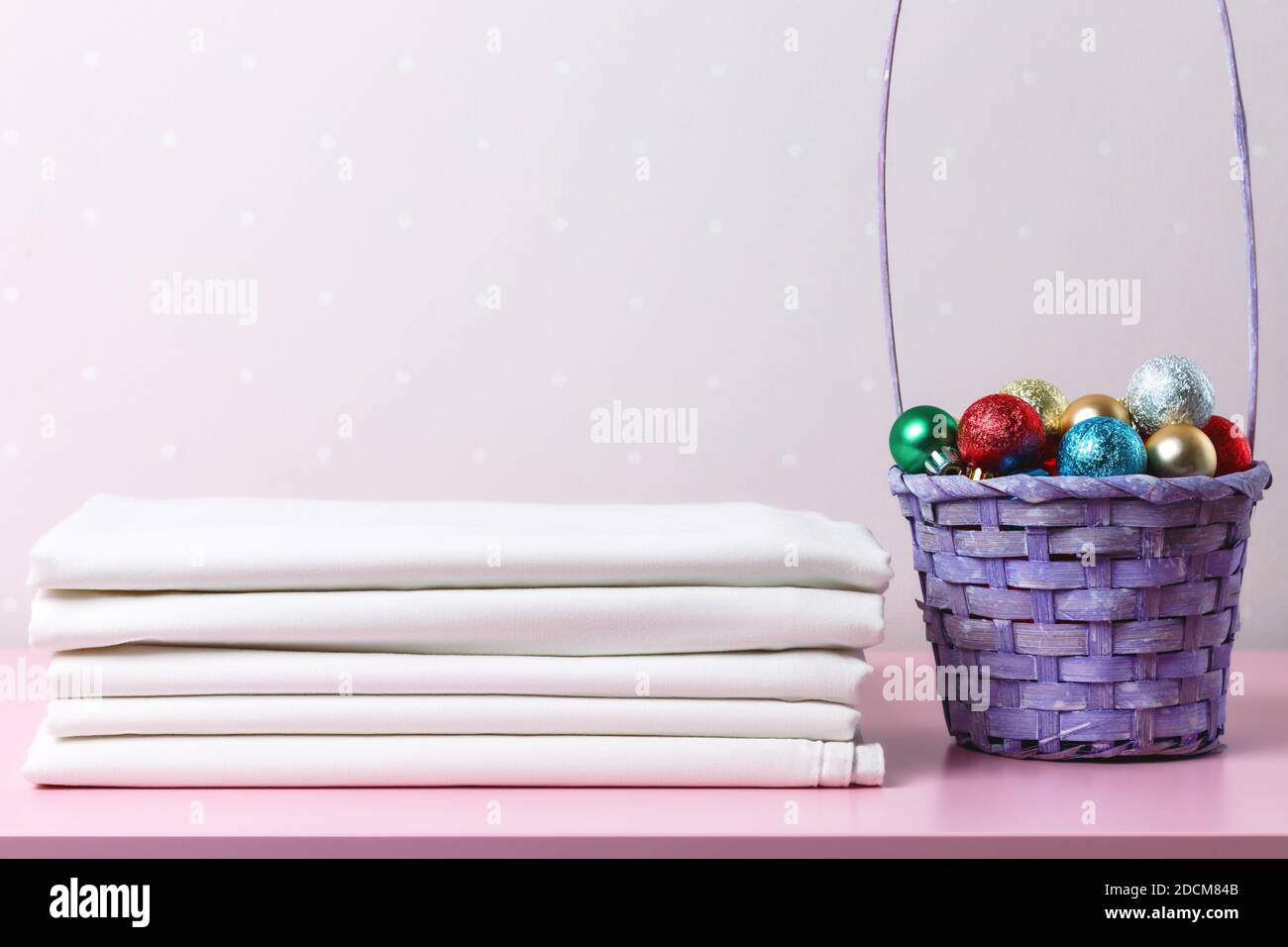 Una pila di fogli bianchi puliti e un cestino di palle di Natale. Foto Stock