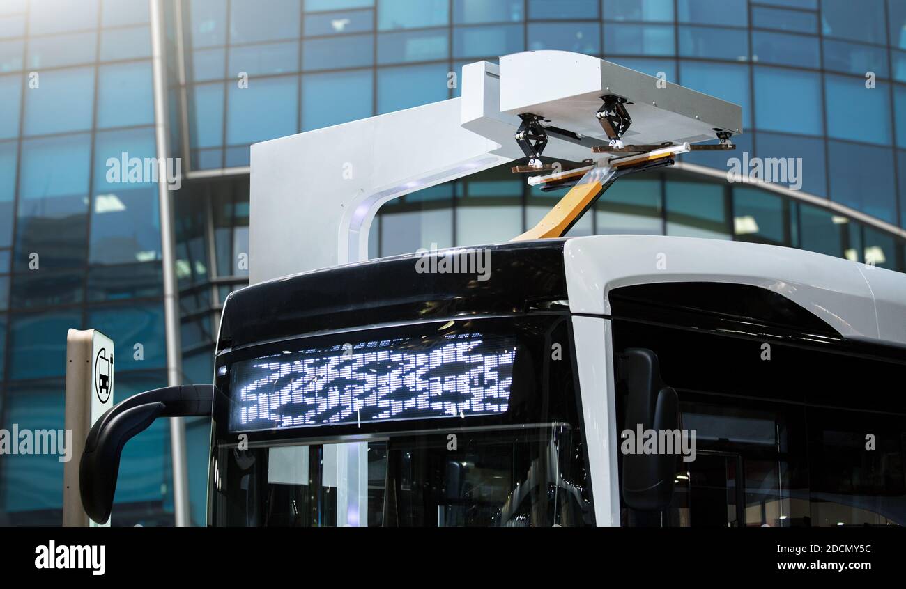 Il bus elettrico a una fermata è a pagamento da pantografo Foto Stock