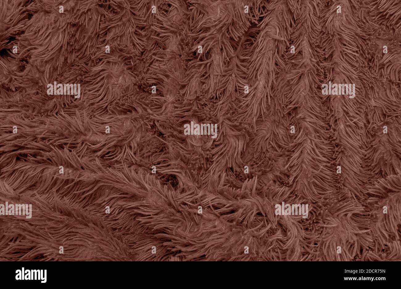 sfondo astratto di dettaglio motivo lucido tessuto pelliccia agugliata con fibre lunghe. Poliestere sintetico o naturale morbido plaid. Confortevole textil casa Foto Stock