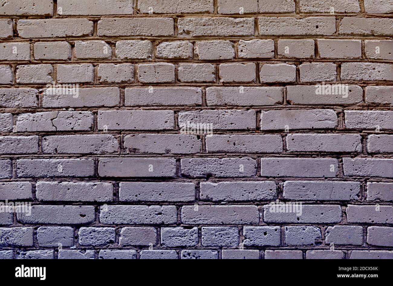 Uno sfondo grigio di texture muraria, mattoni grigi Foto Stock