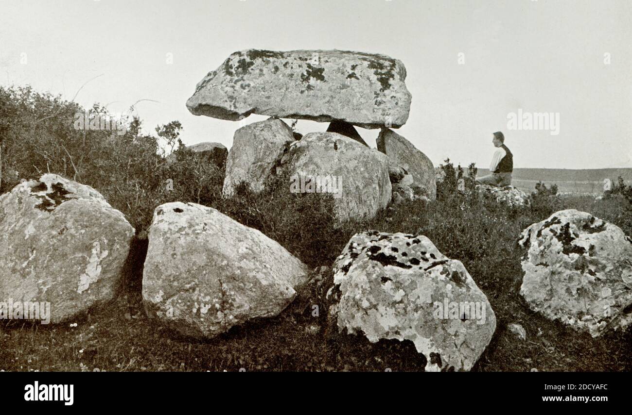 La pietra di Kissing a Carrowmore, Sligo. La pietra di Kissing è il monumento più completo rimasto a Carrowmore, che è stato anche conosciuto come Leaba na Fian durante il periodo vittoriano. Carrowmore è un grande gruppo di monumenti megalitici sulla penisola di Cúil irra vicino Sligo, Irlanda. Furono costruiti nel IV millennio a.C., durante l'epoca neolitica. Ci sono trenta tombe sopravvissute, che collocano Carrowmore tra i più grandi e più antichi complessi di tombe megalitiche in Irlanda. La pietra di Kissing è un cappstone impressionante aggraziato che bilancia sui punti delle tre pietre verticali della camera e copre a s. Foto Stock
