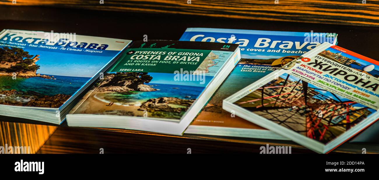 Guide turistiche sulla Costa Brava e Girona in inglese e russo su uno scaffale dell'Hotel Alàbriga vicino a Sant Feliu de Guíxols, Spagna. Foto Stock