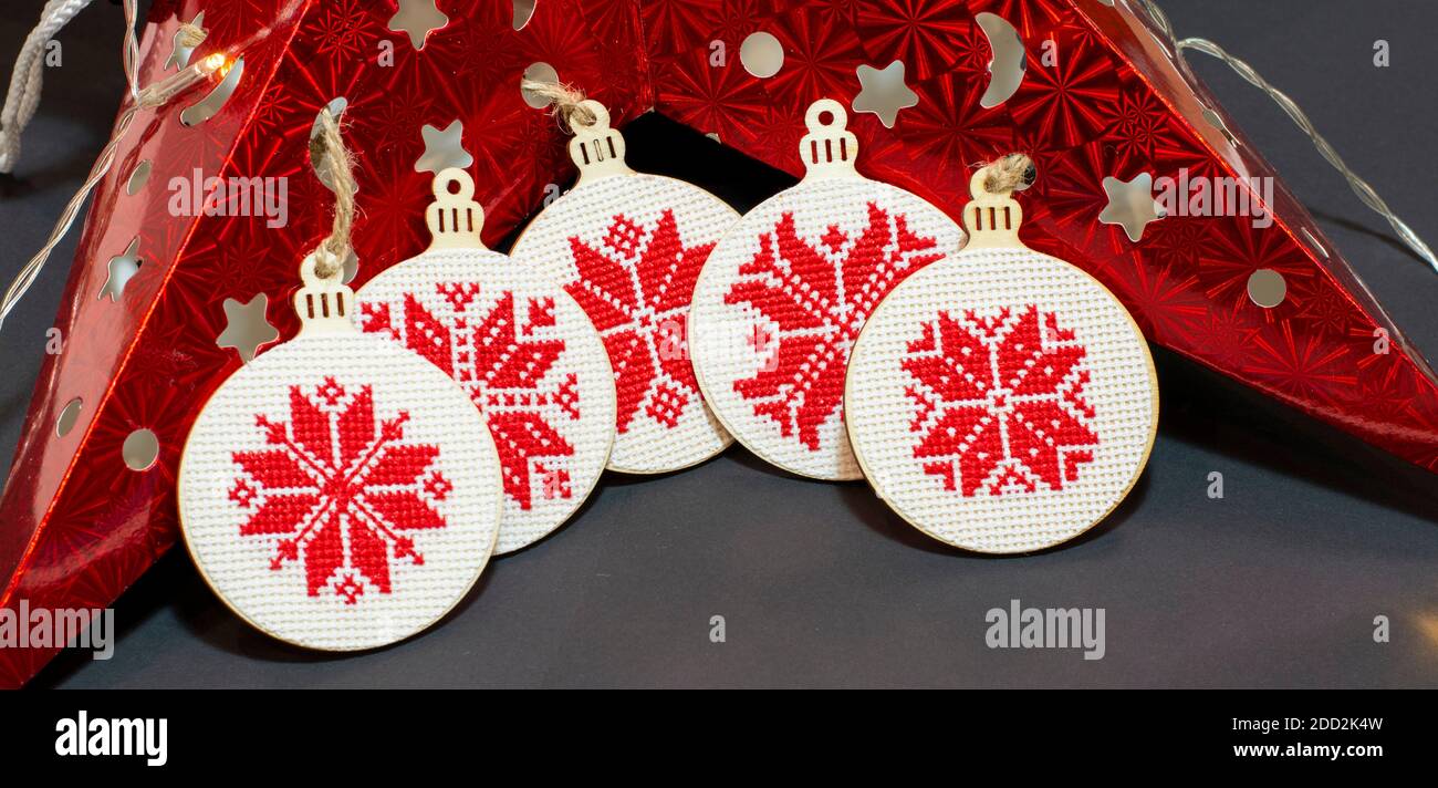 Ricamo ornamentale di decorazione natalizia con punto a croce fatto a mano. Fiocchi di neve nordici. Foto Stock