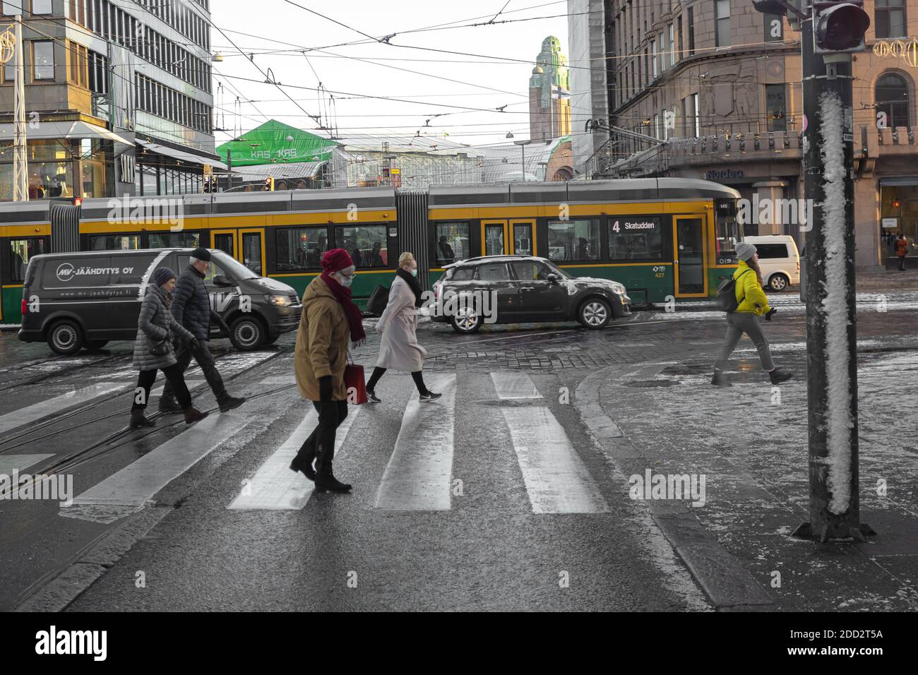 Helsinki, Finlandia 20 novembre 2020 persone attraversano la strada, prima neve sulle strade della città. Foto di alta qualità Foto Stock