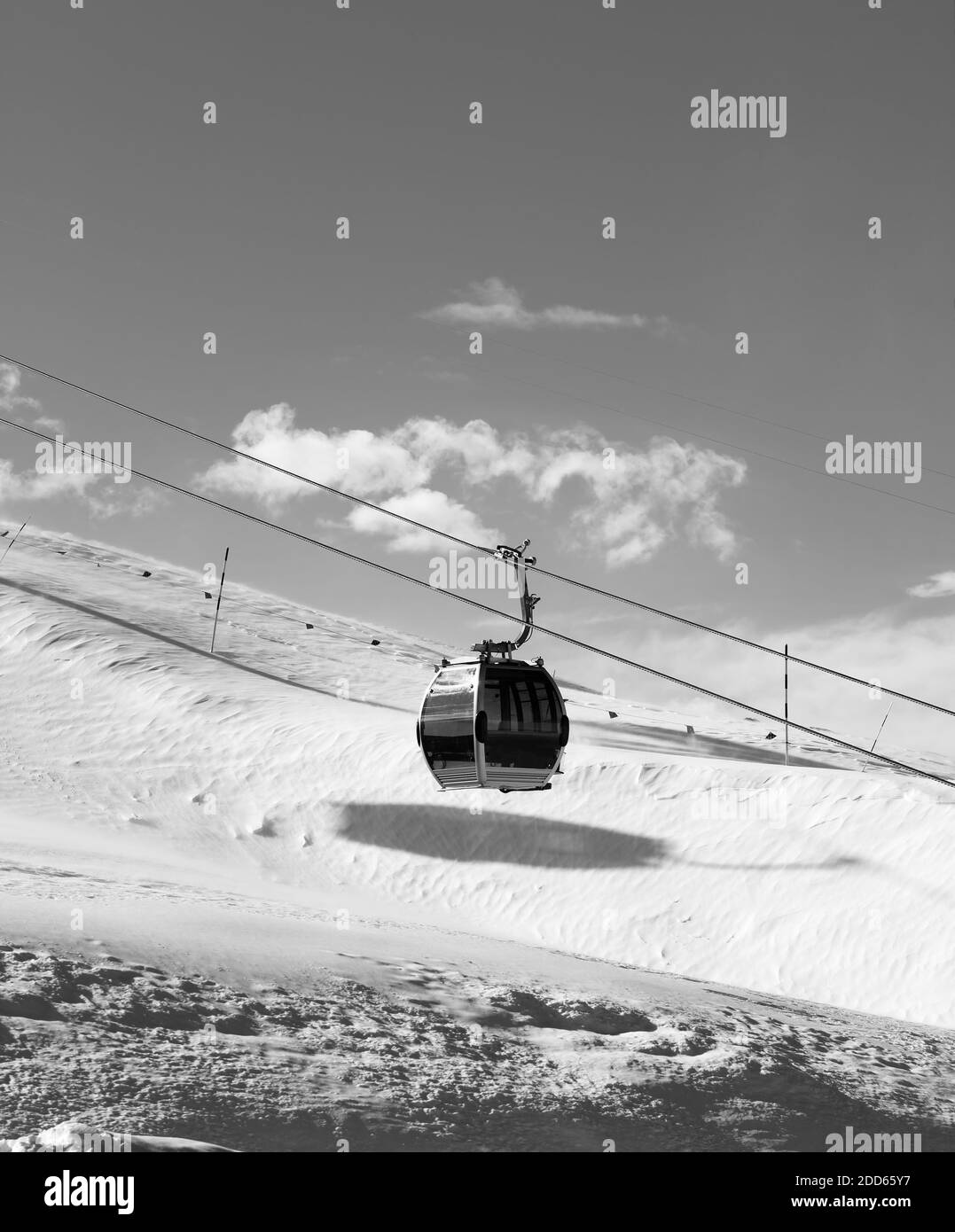 Piste innevate e gondola sulla stazione sciistica al sole ventoso giorno. Montagne del Caucaso in inverno, Shahdagh, Azerbaigian. Immagine in bianco e nero. Alta con Foto Stock