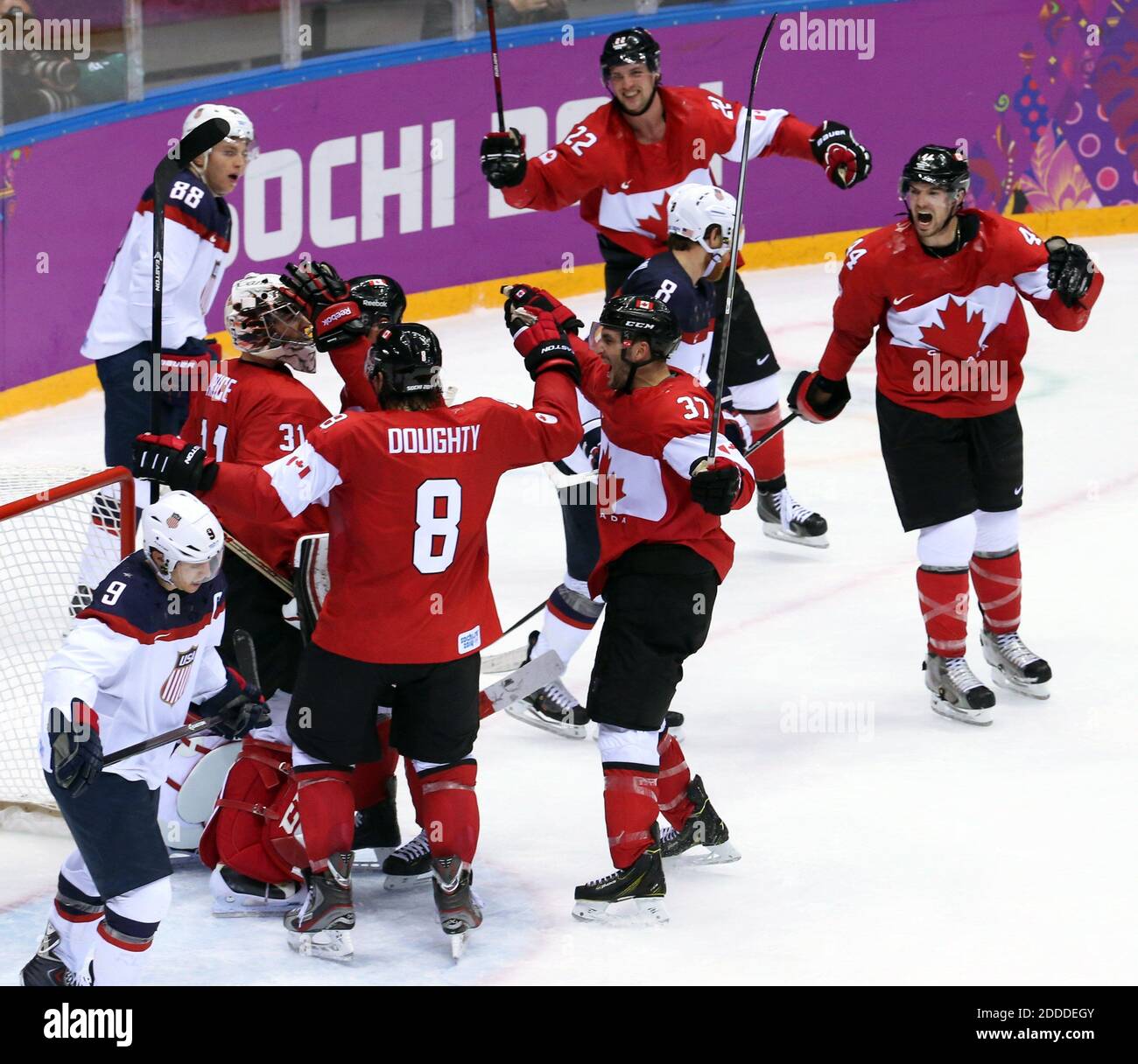 NO FILM, NO VIDEO, NO TV, NO DOCUMENTARIO - Canada mobs goalie Carey Price (31) per celebrare la loro vittoria come i giocatori degli Stati Uniti Patrick Kane (88), Zach Parise (9) e Joe Pavelski (8) skate away dopo una semifinale maschile hockey al Bolshoy Ice Dome durante le Olimpiadi invernali di Sochi, Russia, Venerdì 21 febbraio 2014. Il Canada ha sconfitto gli Stati Uniti 1-0 per avanzare alla partita della medaglia d'oro. Foto di Brian Cassella/Chicago Tribune/MCT/ABACAPRESS.COM Foto Stock