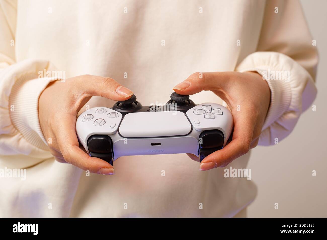 PlayStation 5 Sony svela console e giochi per PS5. Controller Dualsense. Donna che tiene il joystick Foto Stock