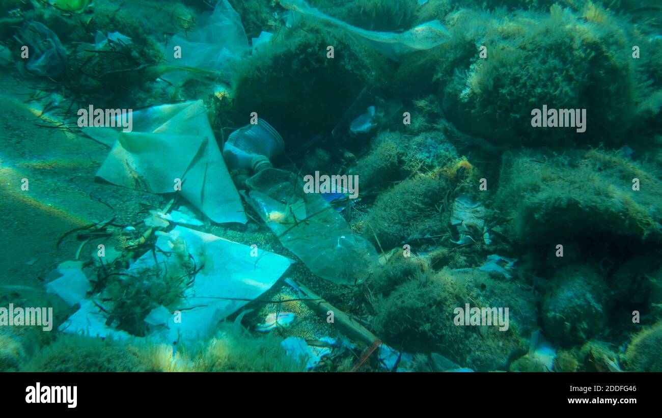 Fondo marino coperto con un sacco di rifiuti di plastica. Bottiglie, borse e altri detriti di plastica sul fondo marino dell'Adriatico. Inquinamento plastico dell'oceano. Adriat Foto Stock