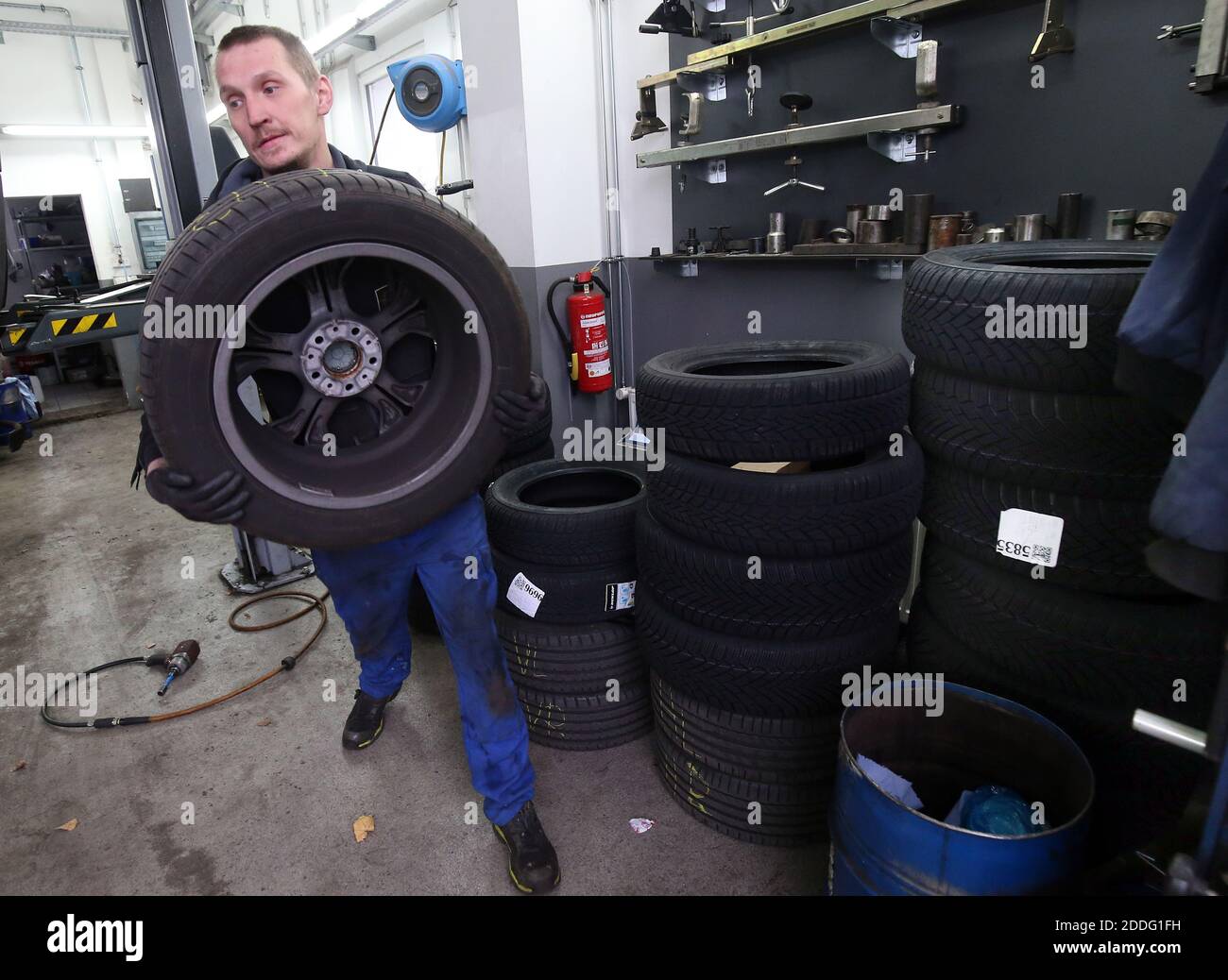 Berlino, Germania. 25 Nov 2020. Un meccanico presso un'officina di riparazione auto nel distretto di Lichtenberg cambia un veicolo da pneumatici estivi a pneumatici invernali. La regola generale per un cambio stagionale di pneumatico è: Da A a o (giorno di tutti i Santi a Pasqua). Chiunque abbia un incidente con gli pneumatici estivi nonostante le cattive condizioni atmosferiche pagherà una multa pesante (requisito degli pneumatici invernali). Gli pneumatici invernali sono più efficaci quando la temperatura media è inferiore a sette gradi Celsius. Credit: Wolfgang Kumm/dpa/Alamy Live News Foto Stock