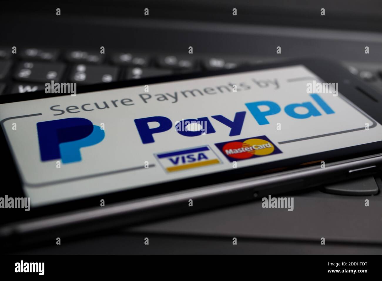 Viersen, Germania - 9 maggio. 2020: Primo piano del telefono cellulare isolato con la società di servizi a pagamento Paypal logo scritta sulla tastiera del computer Foto Stock