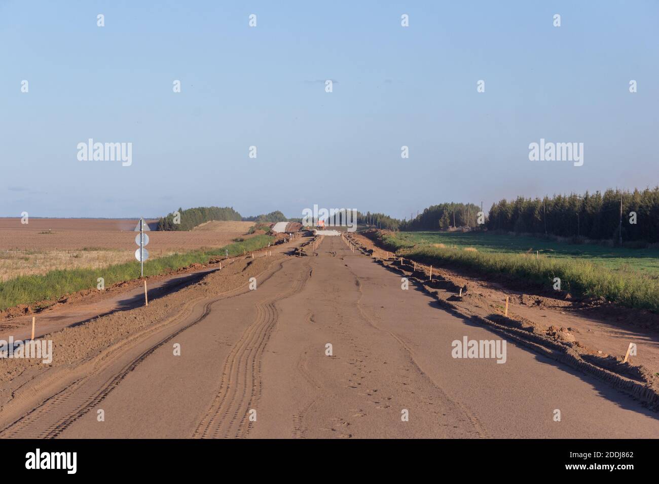 Costruzione di una nuova strada. Uno degli strati di una miscela di ciottoli di fiume e sabbia durante la pavimentazione di nuovo asfalto. Tecnologia per la costruzione di autostrade Foto Stock