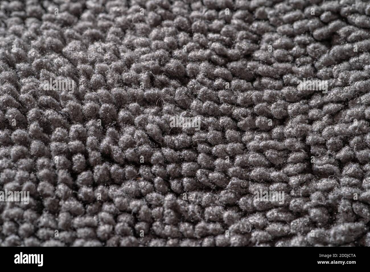 Superficie in tessuto tessuto grigio microfibra, macrofotografia. Foto Stock