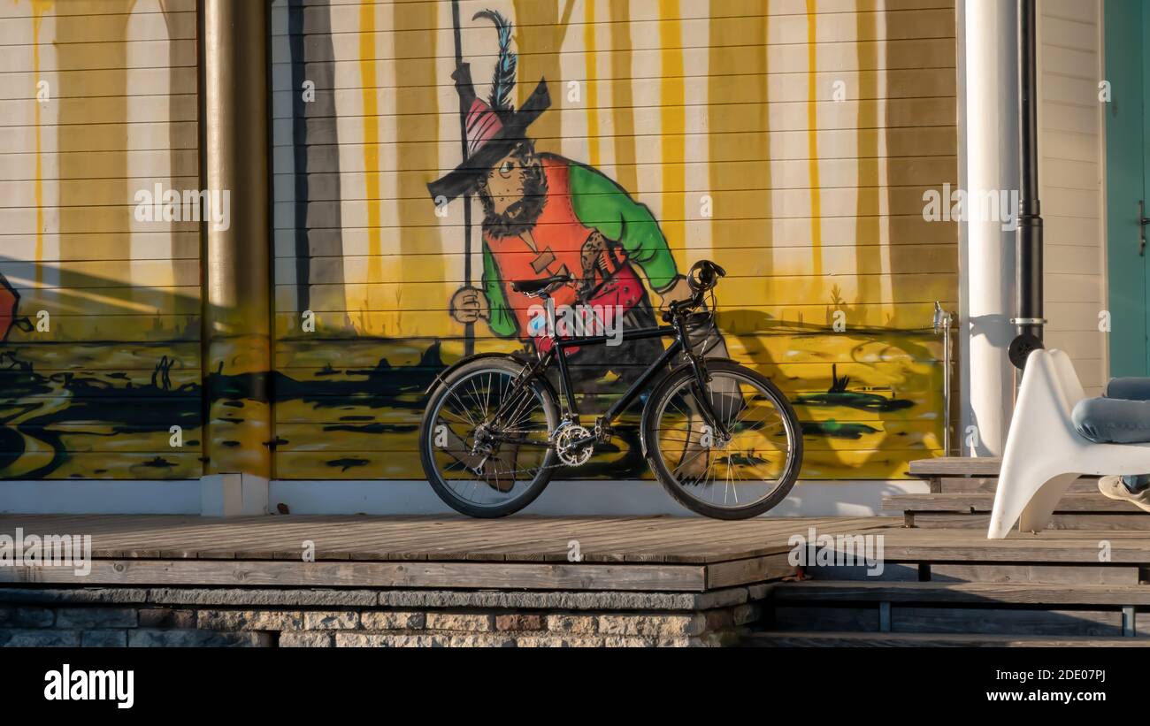 Una bicicletta parcheggiata e una figura divertente sullo sfondo Foto Stock