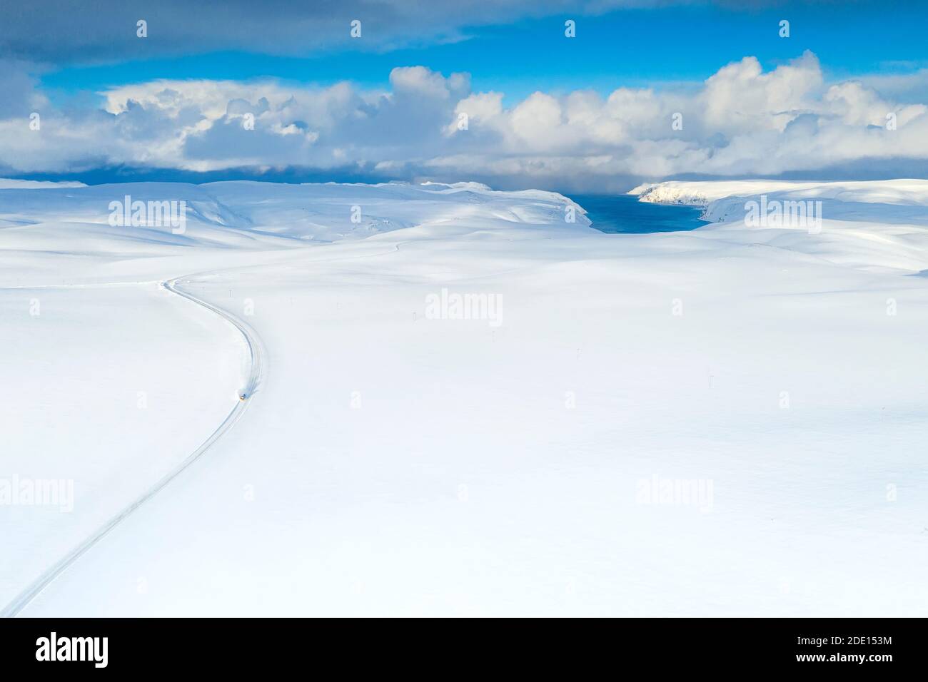 Vista aerea della strada vuota verso Nordkapp (Capo Nord) attraversando il paesaggio coperto da neve profonda, Troms og Finnmark, Norvegia, Scandinavia, Europa Foto Stock