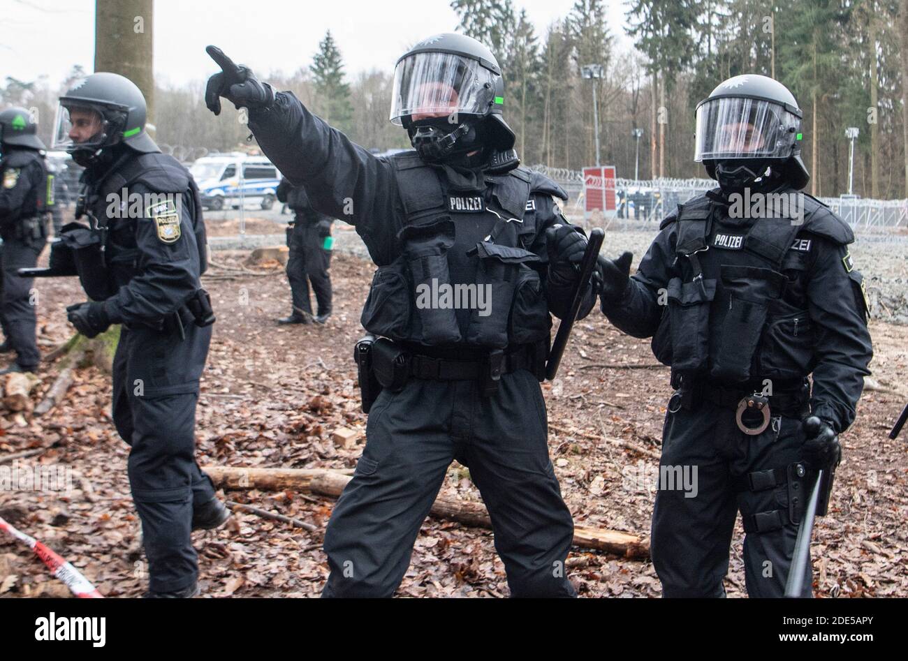 Dannenrod, Germania. 29 Nov 2020. Con i loro truncheon sollevati, la polizia minaccia gli attivisti che si avvicinano al cordone lungo la strada di disboscamento. I protettori ambientali e climatici protestano da mesi nella foresta di Dannenröder contro la controversa e continuata costruzione dell'Autobahn 49. Credit: Boris Roessler/dpa/Alamy Live News Foto Stock