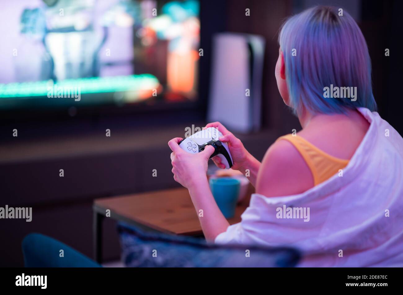 Mosca - Novembre 28 2020: Donna che detiene a casa il nuovo joystick del controller Dualsense della console di gioco Sony PlayStation 5. Giocare con lei Foto Stock