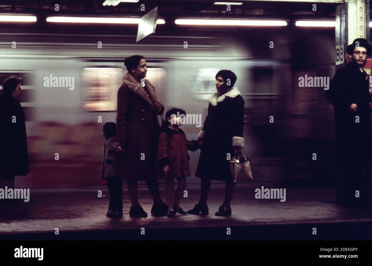 I passeggeri aspettano una metropolitana della linea Lexington Avenue su una delle piattaforme della New York City Transit Authority. CA. 1974 Foto Stock