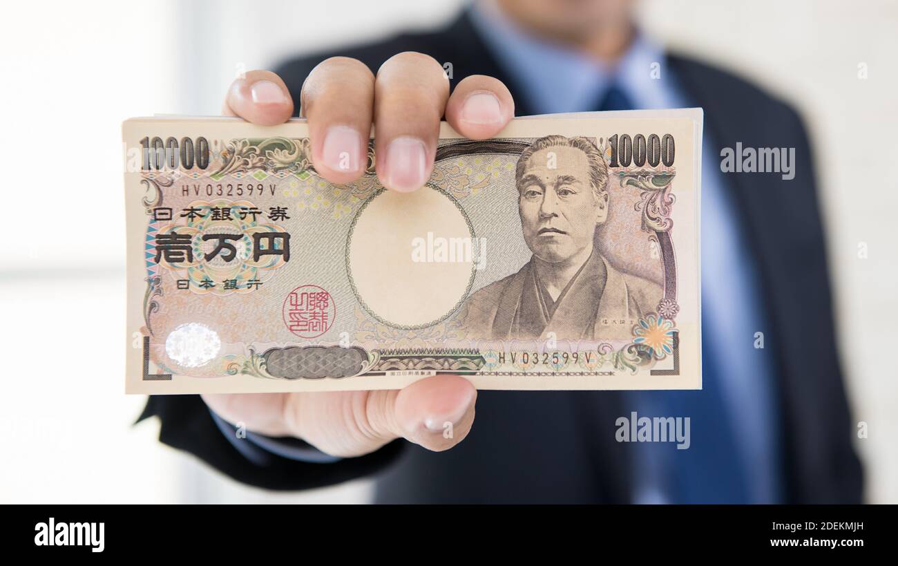 Ricco uomo d'affari che mostra fino a identificare il vero yen giapponese denaro per investimenti bancari e finanziari Foto Stock