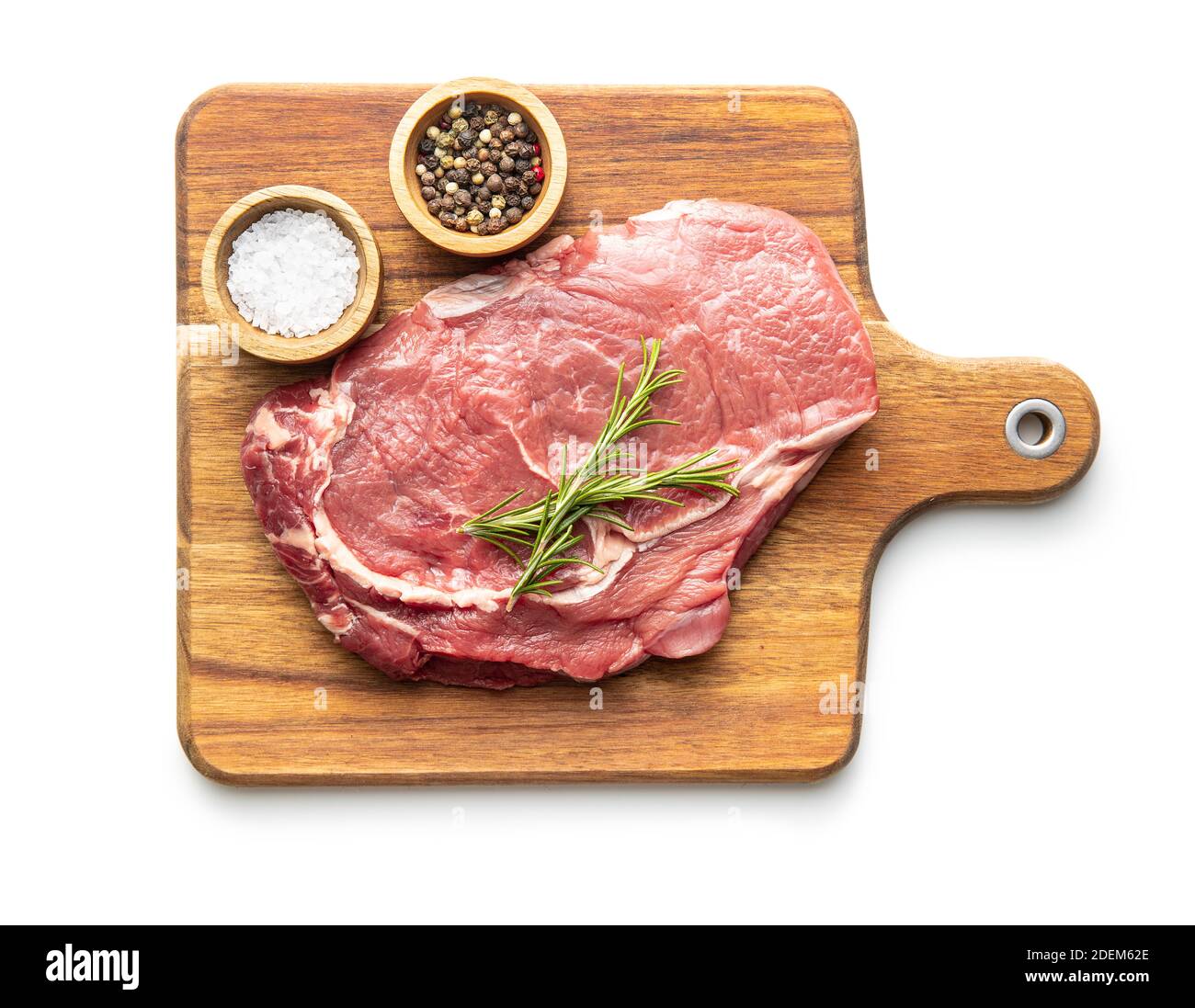 Bistecca di ribeye grezza a fette su tagliere isolato su sfondo bianco. Vista dall'alto. Foto Stock