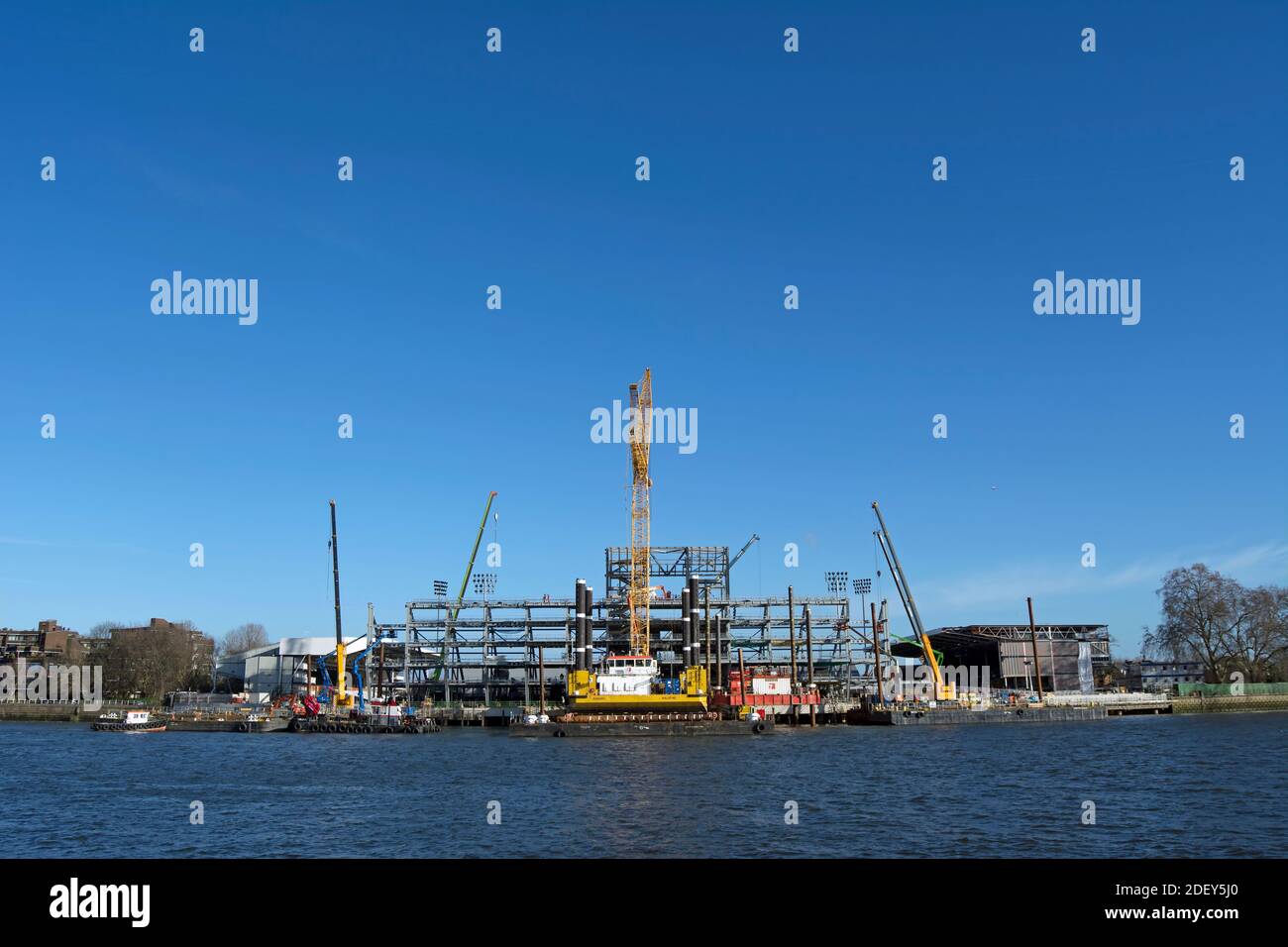 costruzione dello stand lungo il fiume presso il cottage craven, sede della squadra di calcio fulham, visto dall'altra parte del fiume tamigi a barnes Foto Stock