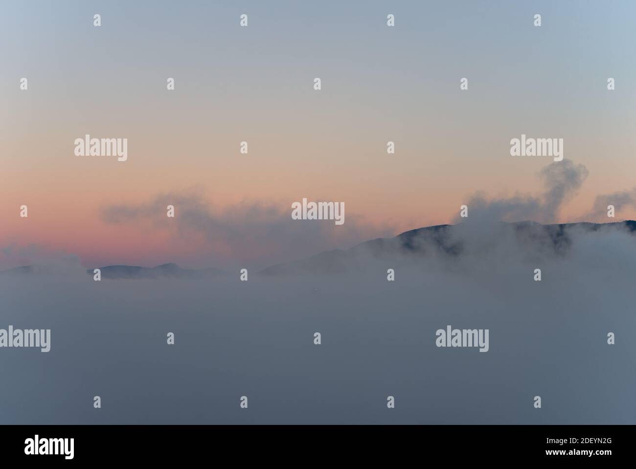 Vancouver City Mountains sopra la nebbia con il sole del mattino che creano un falso tramonto riflettente, come un montatura di immagine Olympus dio Foto Stock