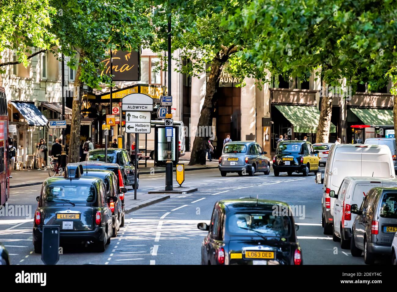 Londra, Regno Unito - 22 giugno 2018: Vista ad alto angolo della strada con alberi verdi in città con taxi auto su Aldwych Street nel centro della città e segni Foto Stock