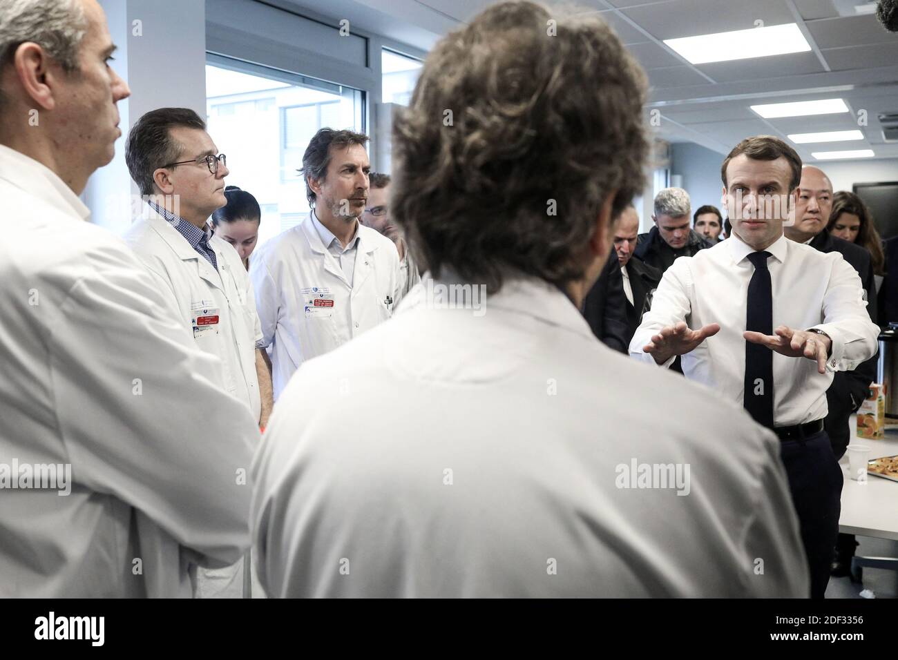 Il presidente francese Emmanuel Macron, affiancato dal presidente AP-HP Martin Hirsch e dal ministro francese della Sanità Olivier Veran, incontra il personale medico mentre visita l'ospedale di Pitie-Sampetriere a Parigi il 27 febbraio 2020, dove la prima vittima francese della COVID-19 è scomparsa il giorno prima. La Francia ha finora registrato 18 infezioni e due decessi, un cittadino francese di 60 anni e un turista cinese di 80 anni, mentre i governi europei si sforzano di contenere una serie di nuovi casi di coronavirus che si sono verificati in tutto il continente. Foto di Stephane Lemouton/ABACAPRESS.COM Foto Stock