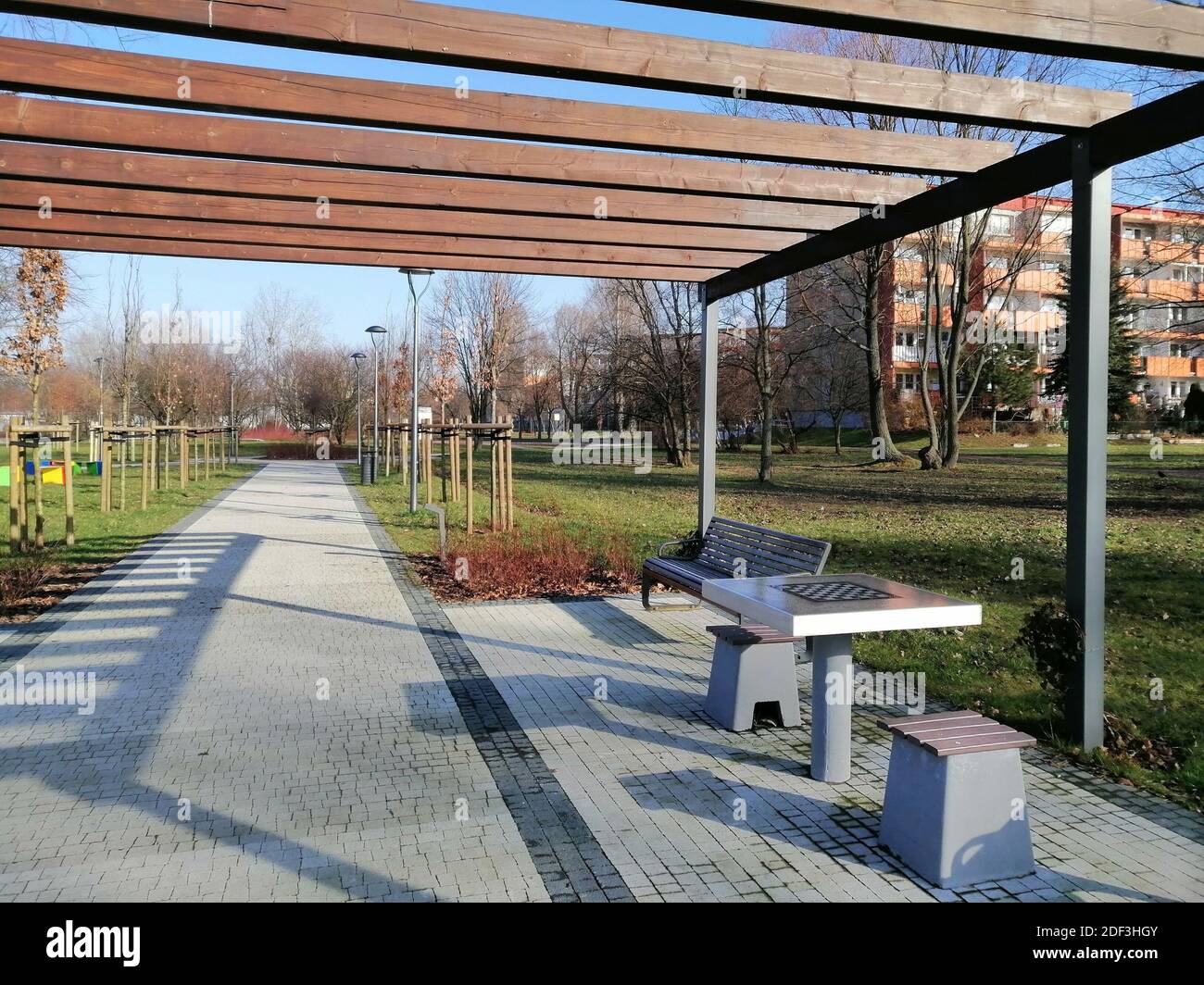 Scacchiera sul tavolo e panchine in cortile durante il giorno Foto Stock