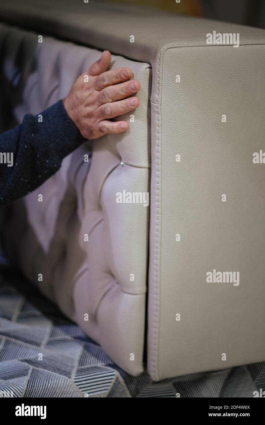 Un colpo verticale del lavoratore che installa la testata con i rhinestones Foto Stock