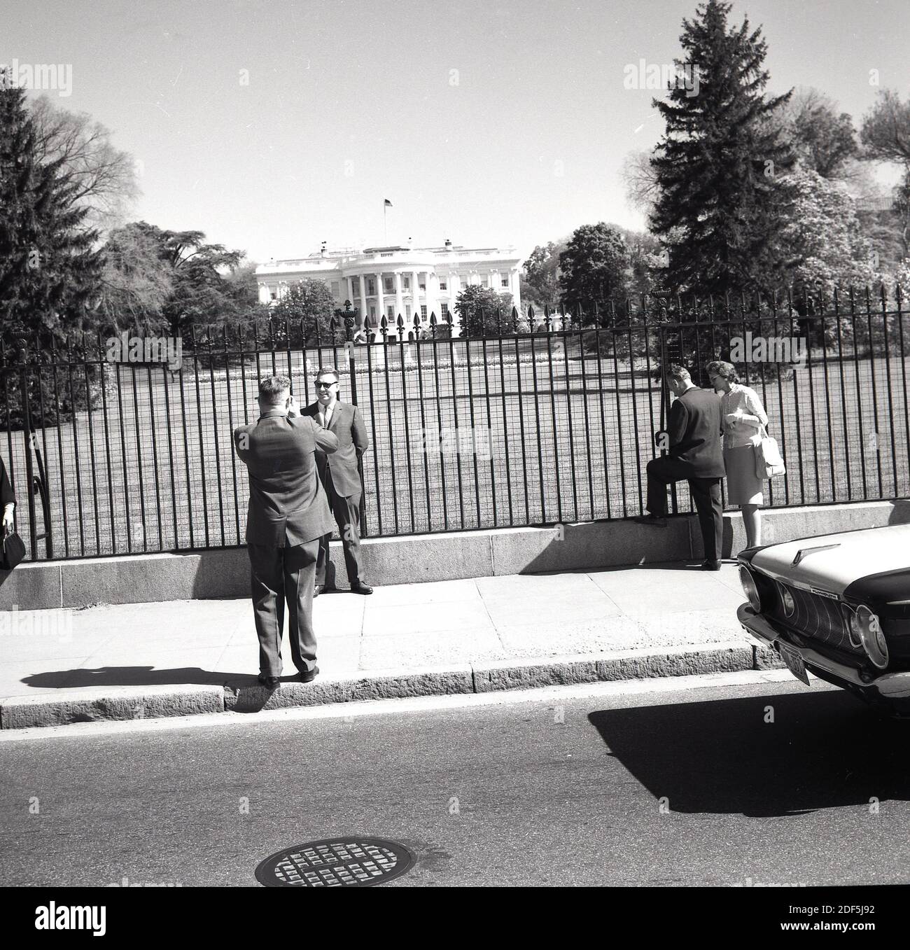 Anni '1960, storico, Washington DC, USA, persone che scattano foto alla recinzione perimetrale che circonda la Casa Bianca, casa e ufficio del Presidente degli Stati Uniti. Qui si vede la facciata meridionale della residenza esecutiva, notevole per il suo semi-portico che si affaccia sul South Lawn. Foto Stock