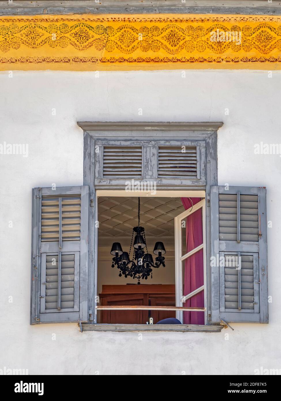 Ricordi veneziani. La striscia dorata e il lampadario vintage che vediamo attraverso la finestra aperta fanno parte di una facciata di casa glamour, Foto Stock
