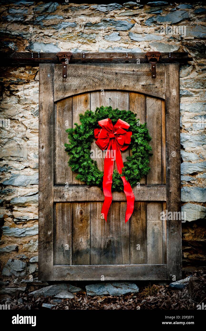Porta in legno decorata con wreathe natalizie Foto Stock