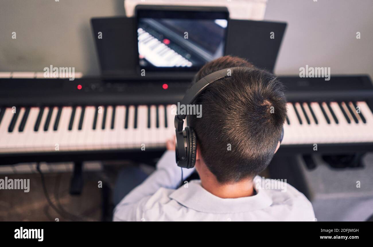 Bambini imparare piano online lezioni in quarantena . Stile di vita del coronavirus Foto Stock