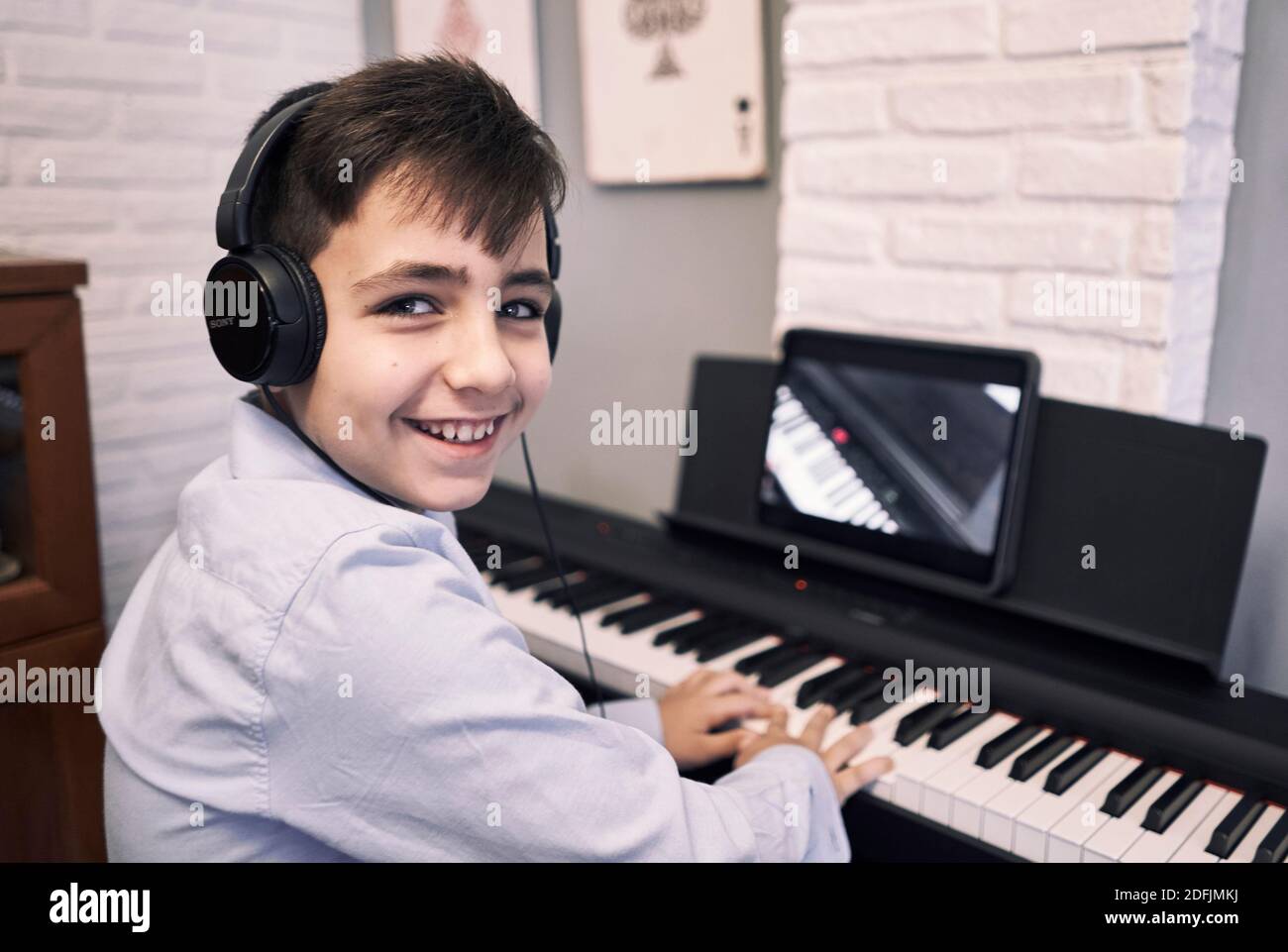 Bambini imparare piano online lezioni in quarantena . Stile di vita del coronavirus Foto Stock