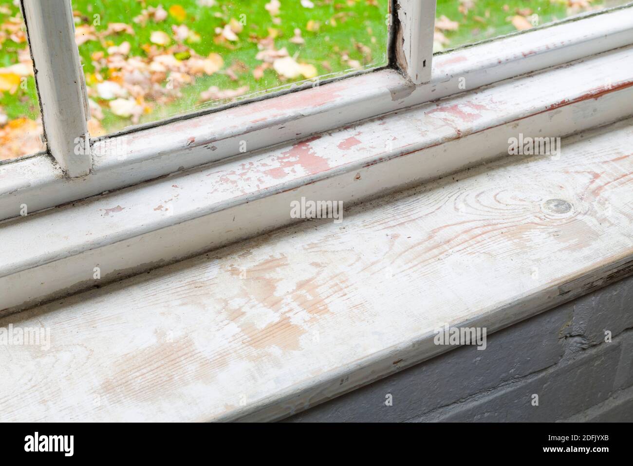 Riparazione o restauro di finestre, levigatura di finestre interne in legno in una casa, Regno Unito Foto Stock