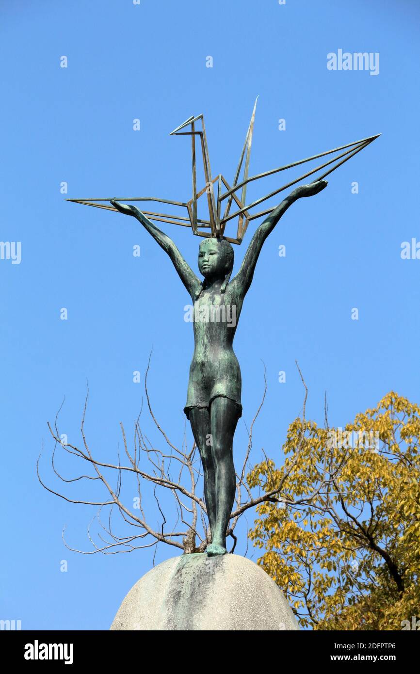 Hiroshima Japan Peace Park Children's Monument. La statua sulla sommità del monumento raffigura Sadako Sasaki che regge una gru di carta triste e riflettente Foto Stock