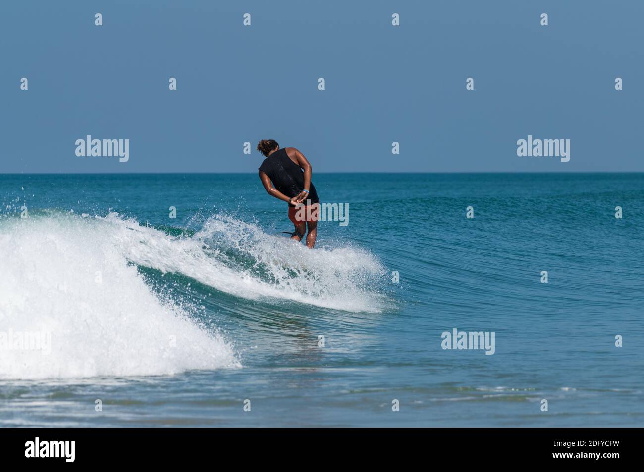 VARKALA, INDIA - Mar 14, 2020: Un indiano Maschile Surf nelle onde con stile Foto Stock