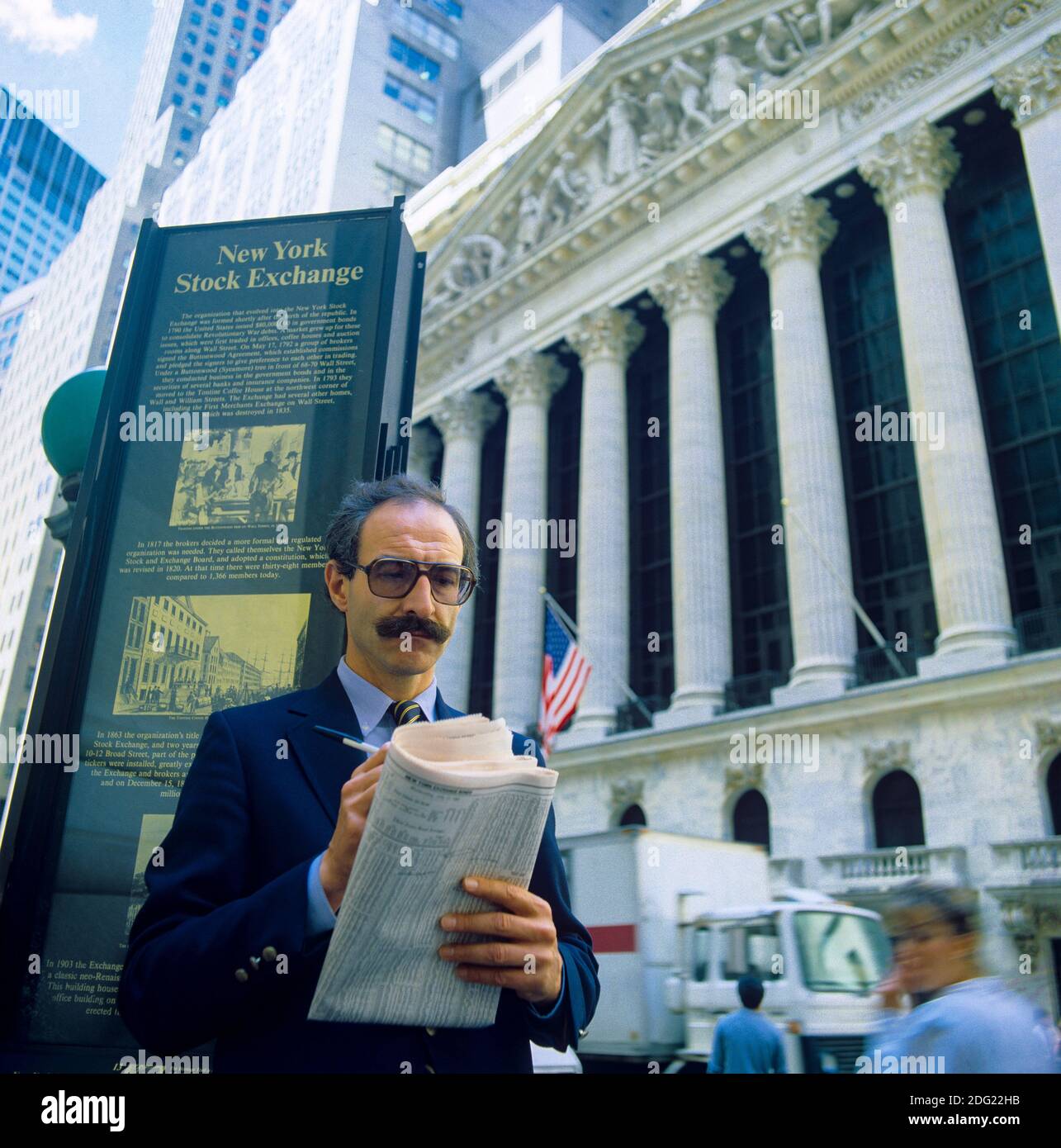 New York 1985, uomo che controlla i prezzi delle azioni nel Wall Street Journal, NYSE Stock Exchange Building Facade, Broad Street, Manhattan, New York City, NY, NYC, STATI UNITI, Foto Stock
