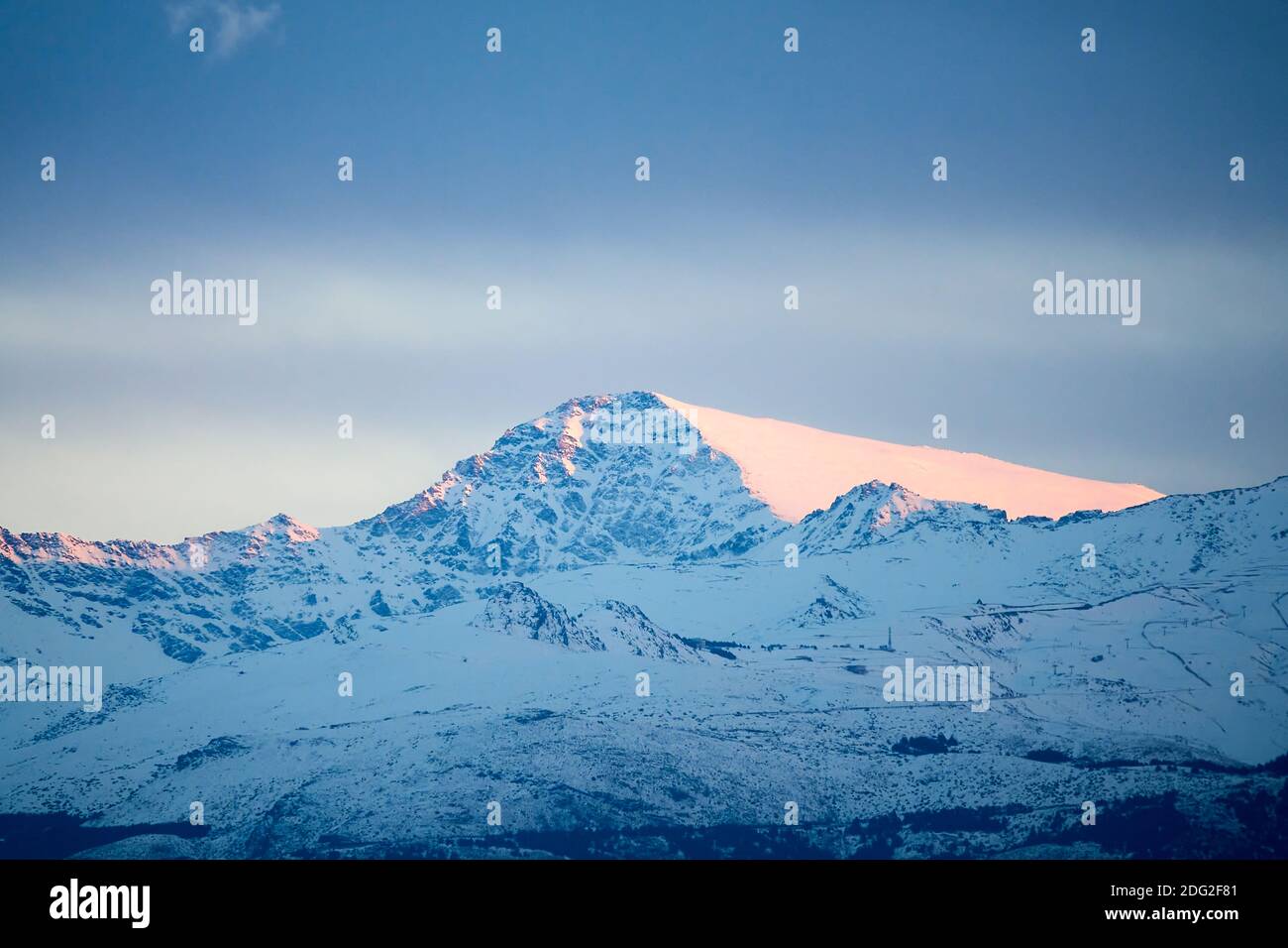 Vista della neve Mulhacen in Sierra Nevada al tramonto; è la vetta più alta della penisola iberica Foto Stock