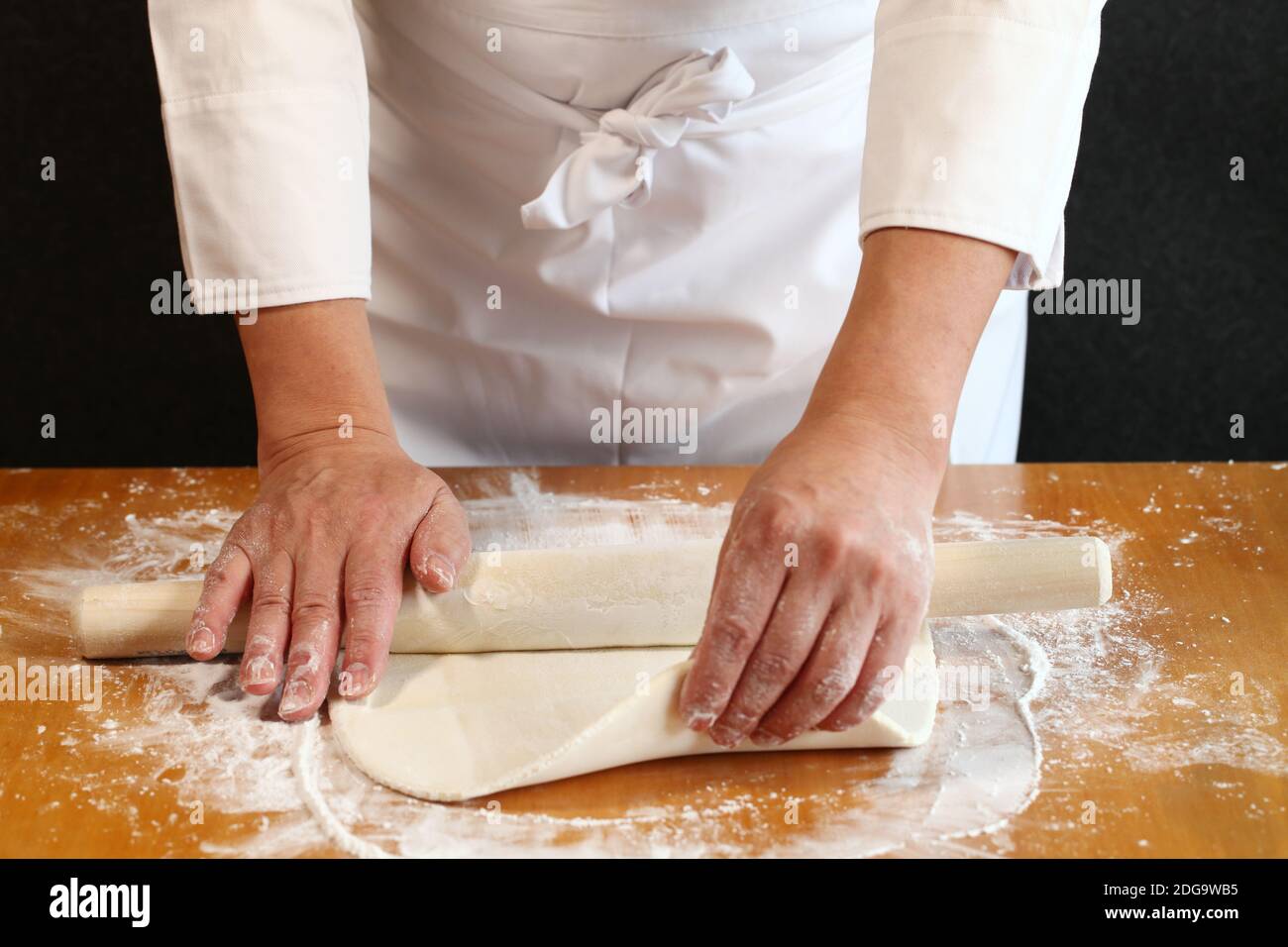 come fare udon giapponesi tagliatelle; usare un tondino per arrotolare l'impasto Foto Stock