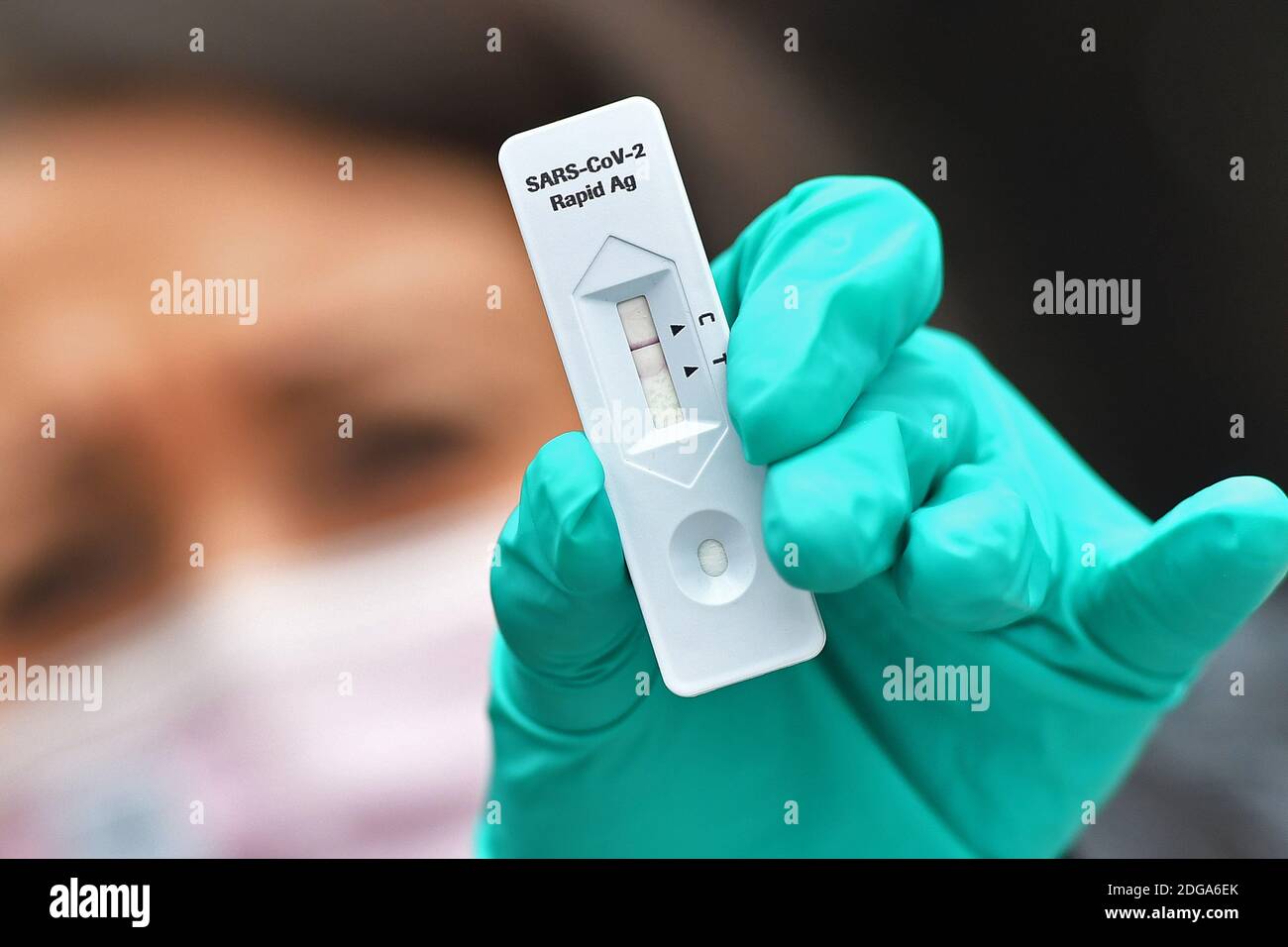 Monaco, Germania. 06 dicembre 2020. Immagine dell'argomento Test antigene corona. Una giovane donna indossa guanti verdi in lattice e sta facendo un test corona rapido. MODELLO RILASCIATO! | utilizzo in tutto il mondo credito: dpa/Alamy Live News Foto Stock