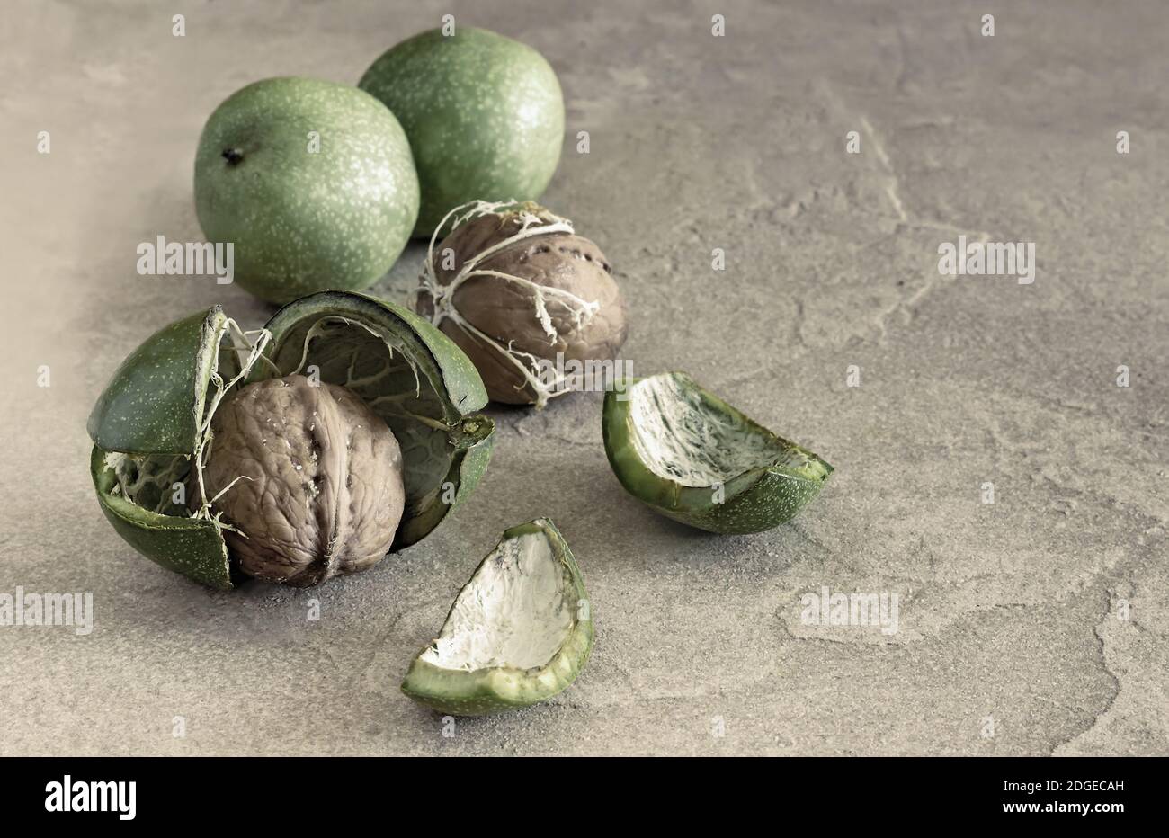 Noci comuni in guscio verde sul tavolo Foto Stock