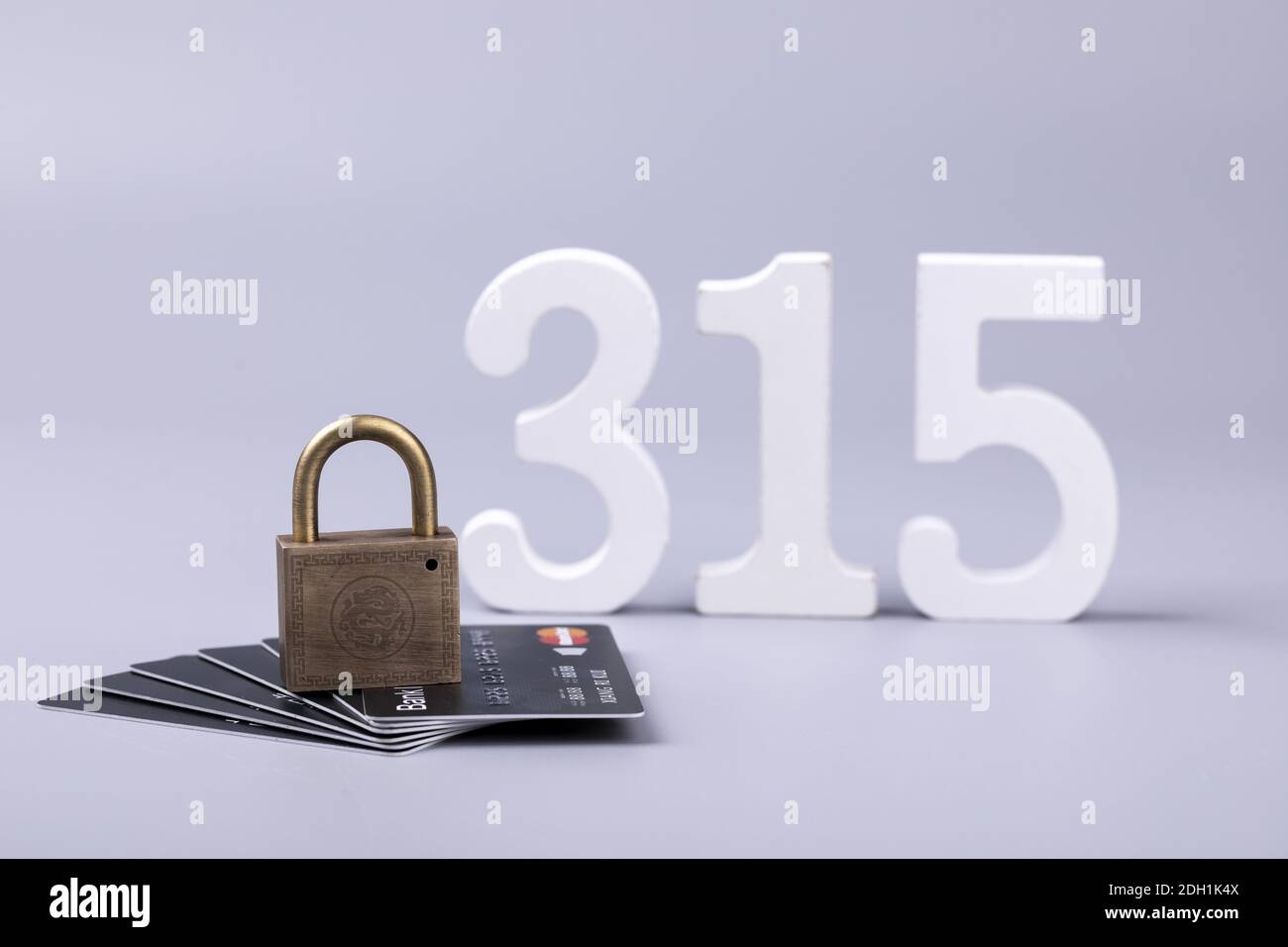 Un primo piano di un lucchetto sulle carte e il numero 315 - concetto di libertà finanziaria Foto Stock
