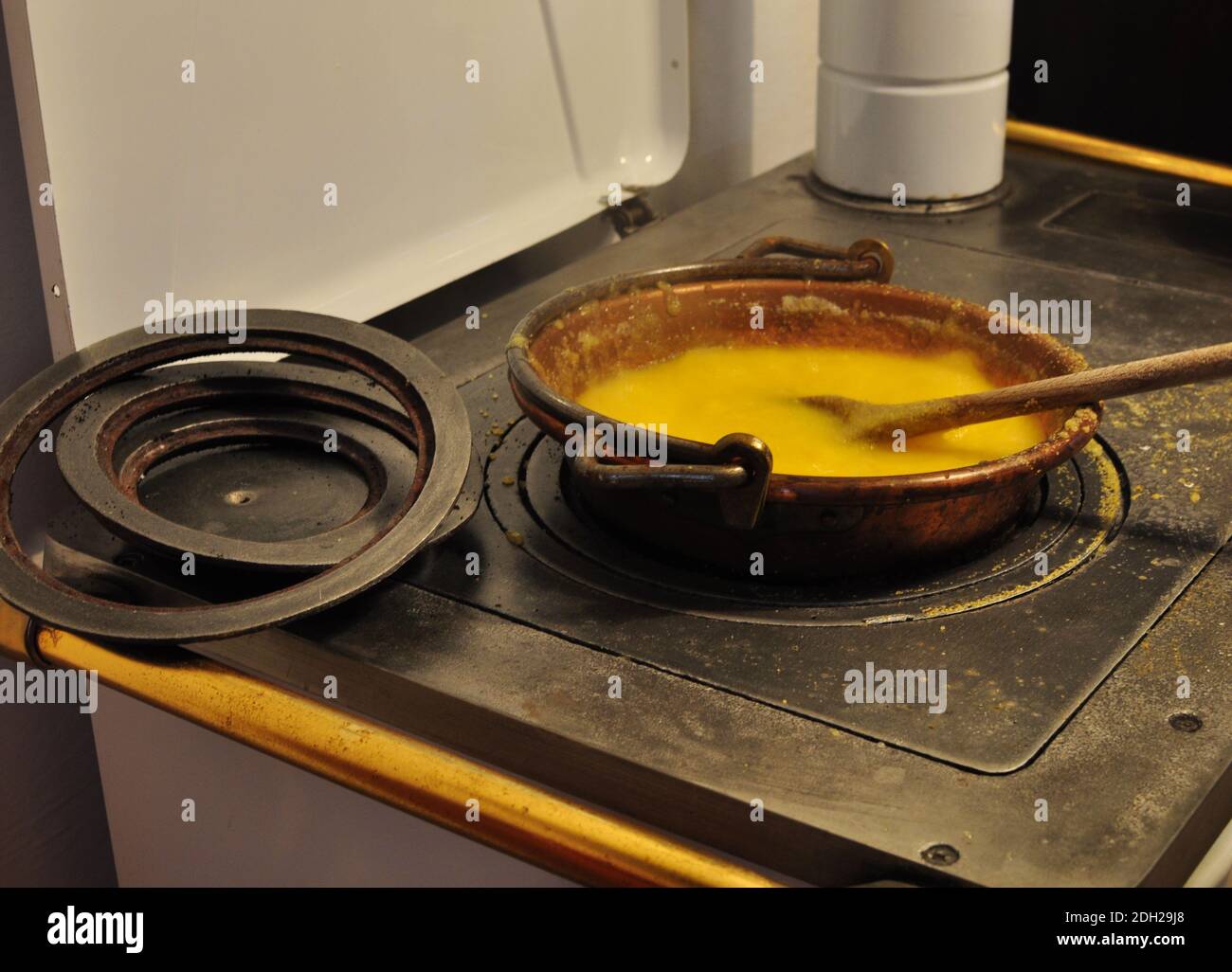 produzione di polenta casalinga direttamente sul fuoco del stufa a legna Foto Stock